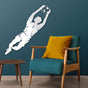 modern room with white metal wall art depicting a goalkeeper diving to catch a soccer ball, mounted on a teal wall above a blue armchair with a yellow cushion.
