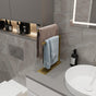 A gold countertop towel holder placed on a bathroom countertop, adding a luxurious touch to the decor while keeping towels neatly organized.