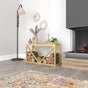 A gold-finished metal log holder with a wooden bench adding a luxurious touch to the living space. The bench accommodates stacked logs, merging functionality with elegance