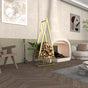 A gold pine tree-shaped firewood rack in an elegant living room setting, filled with neatly stacked firewood, with a fireplace in the background pine tree shaped firewood rack, decorative firewood rack indoor outdoor