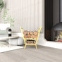 A stylish living room with a gold V-shaped metal wood rack filled with firewood, positioned next to a contemporary fireplace and a coffee table