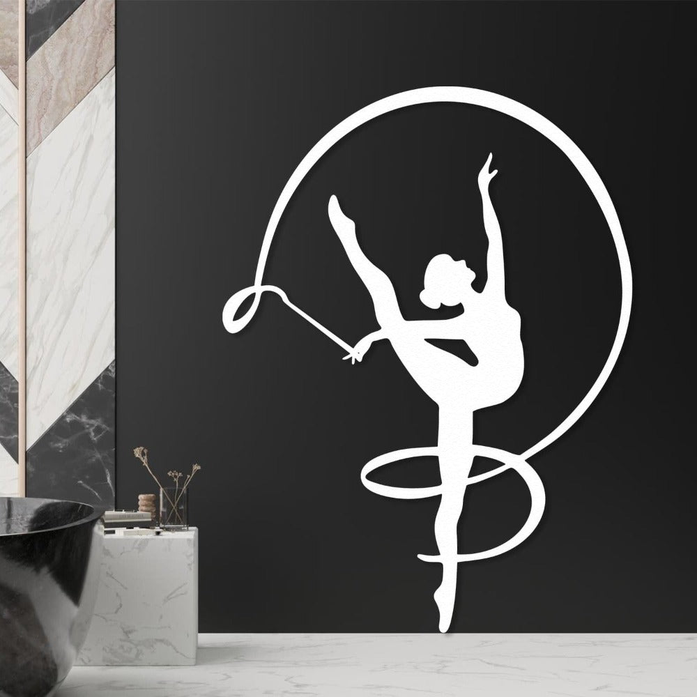 White silhouette of a gymnast girl with a ribbon, elegantly displayed on a black wall in a modern bathroom setting.