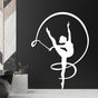 White silhouette of a gymnast girl with a ribbon, elegantly displayed on a black wall in a modern bathroom setting.