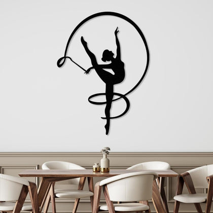 A modern dining area with a gymnast girl metal wall decor featuring a ribbon dance silhouette in black, mounted on a white wall, above a wooden table with elegant chairs