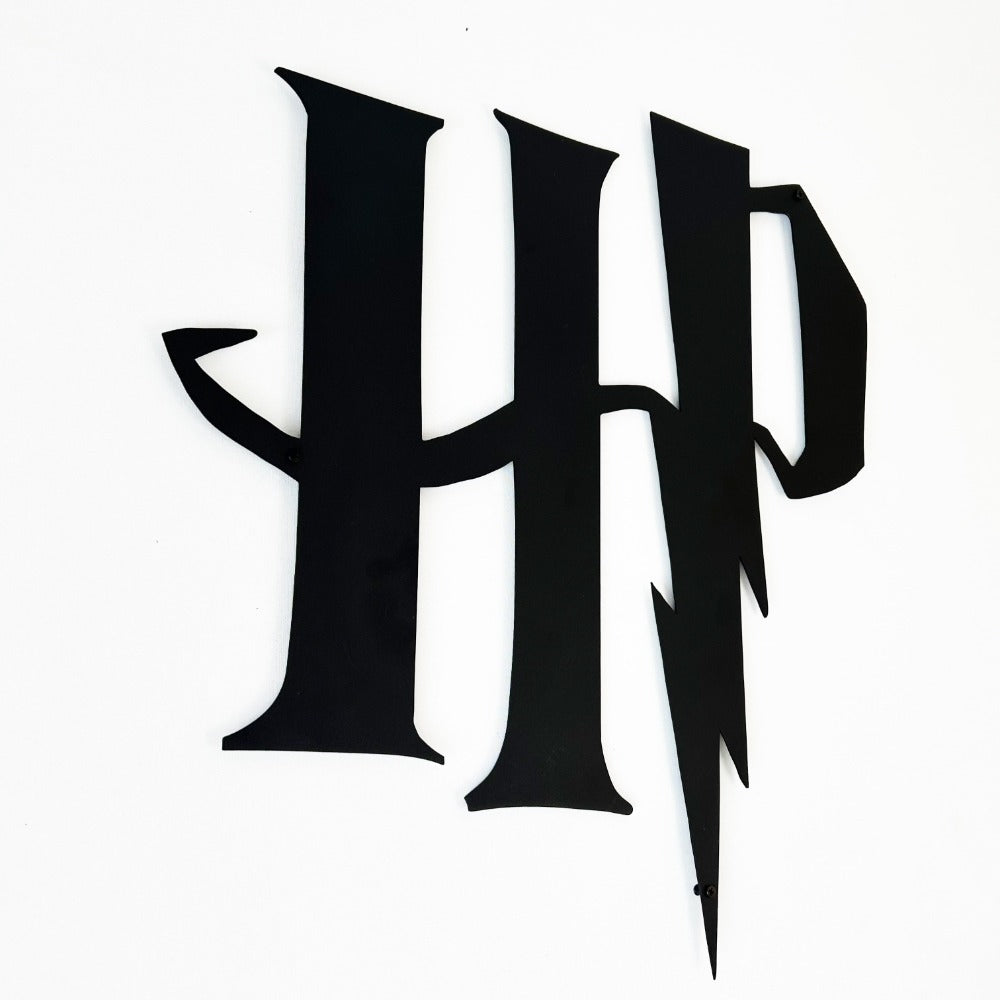 Close-up view of a black Harry Potter "HP" metal logo featuring sharp and bold lightning bolt details.