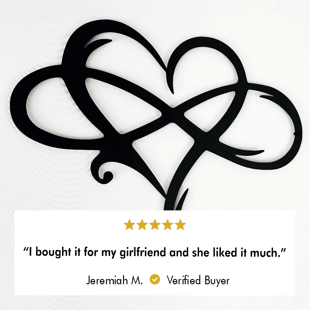 Close-up of black intertwined heart-shaped metal wall art, showing the laser-cut detail.