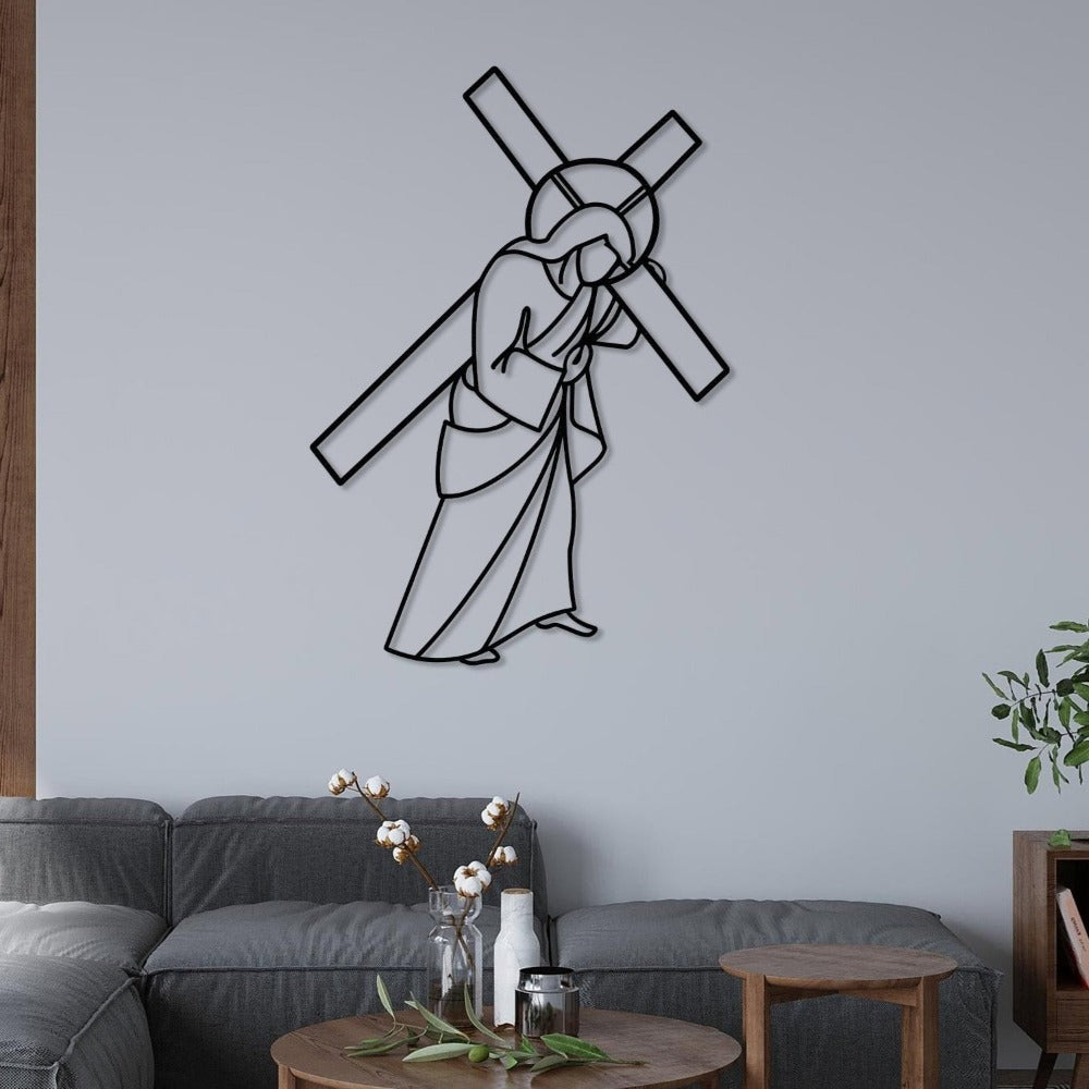 Black Jesus Carrying Cross Metal Wall Art in a living room