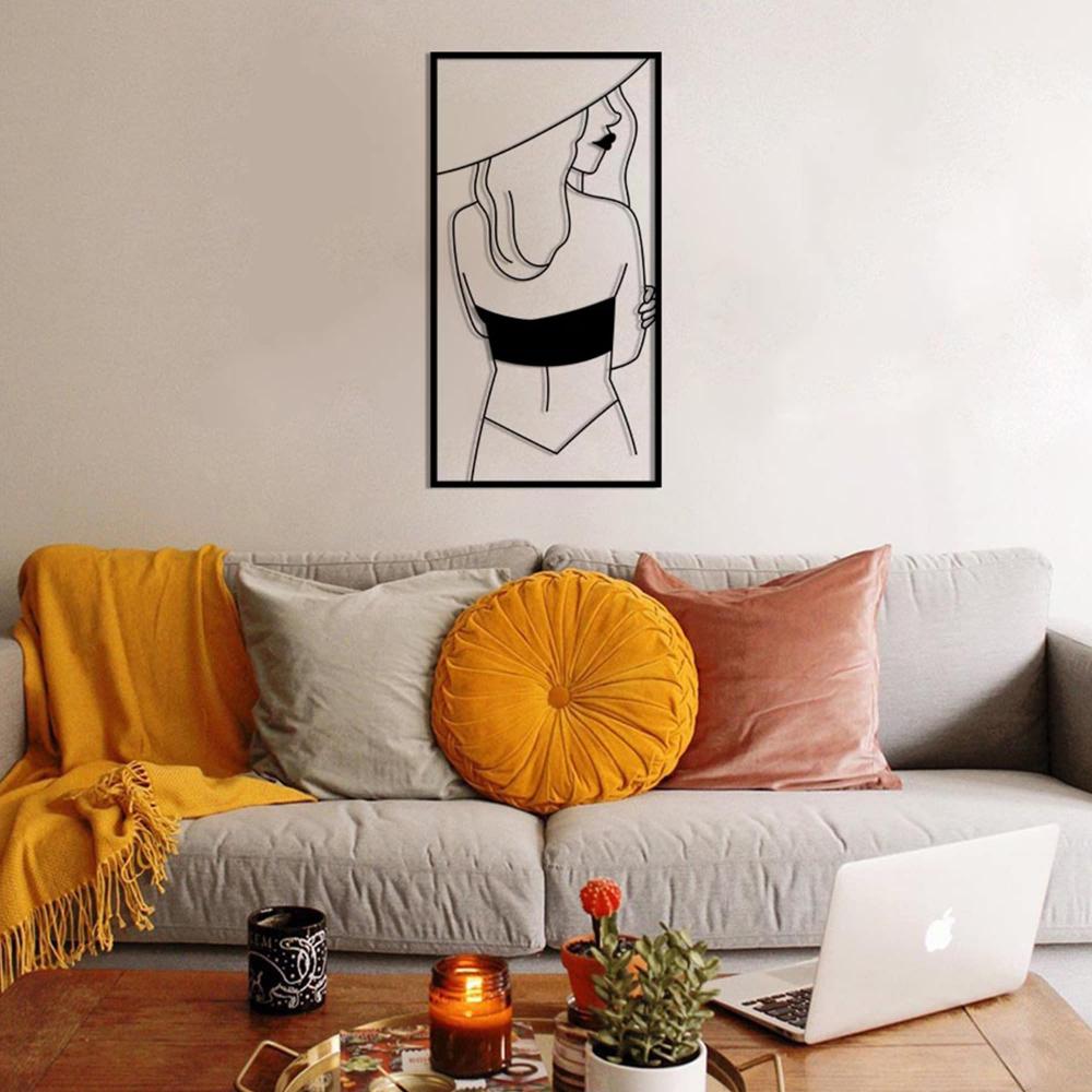 Side-Facing Lady with Hat Metal Wall Art in a living room