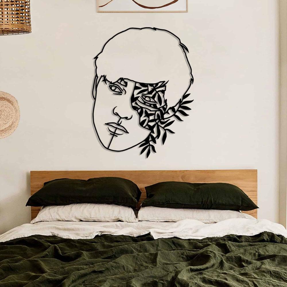 Black Leaf Headed Man Portrait Metal Wall Art in a bedroom