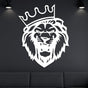 White metal lion head wall art with a crown, elegantly displayed on a dark wall with spotlight accents above a black sofa.