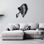  Black metal wall art of an Indian chief's feathered headdress mounted above a stylish grey sectional sofa with modern decor elements.