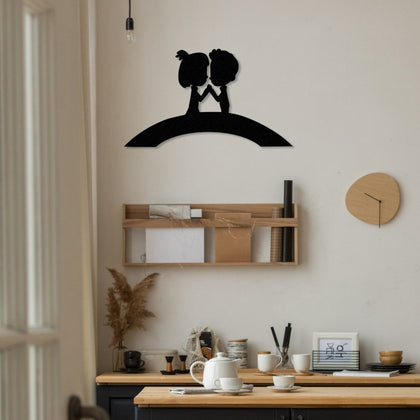 Modern metal art of a couple on a bridge, mounted above a work desk in a bright and contemporary living space with wooden shelves and decorative accents.