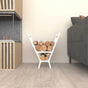 A white minimalist V-shaped metal wood holder positioned indoors beside a contemporary fireplace, filled with stacked firewood