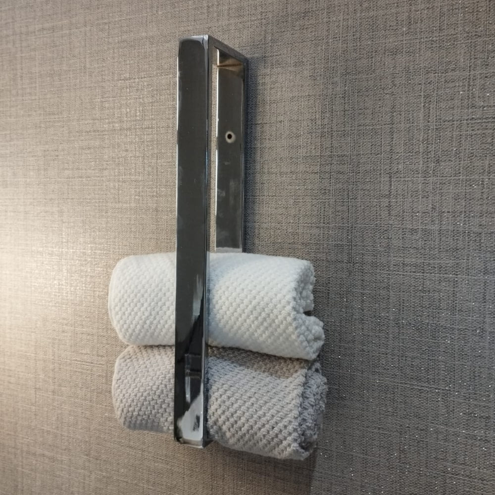 A bathroom wall featuring a chrome towel holder, towels, and a sleek light fixture, creating a modern and organized aesthetic