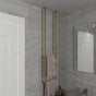 Contemporary bathroom showcasing a stylish gold ceiling-mounted towel rack. The elegant design enhances the modern aesthetic of the space, perfectly complementing the gray tiles. This vertical towel holder provides a luxurious touch while maximizing storage in a minimalist setting.