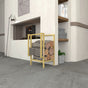 Modern Gold metal firewood and kindling storage placed against a cream-colored wall with built-in shelf decor.