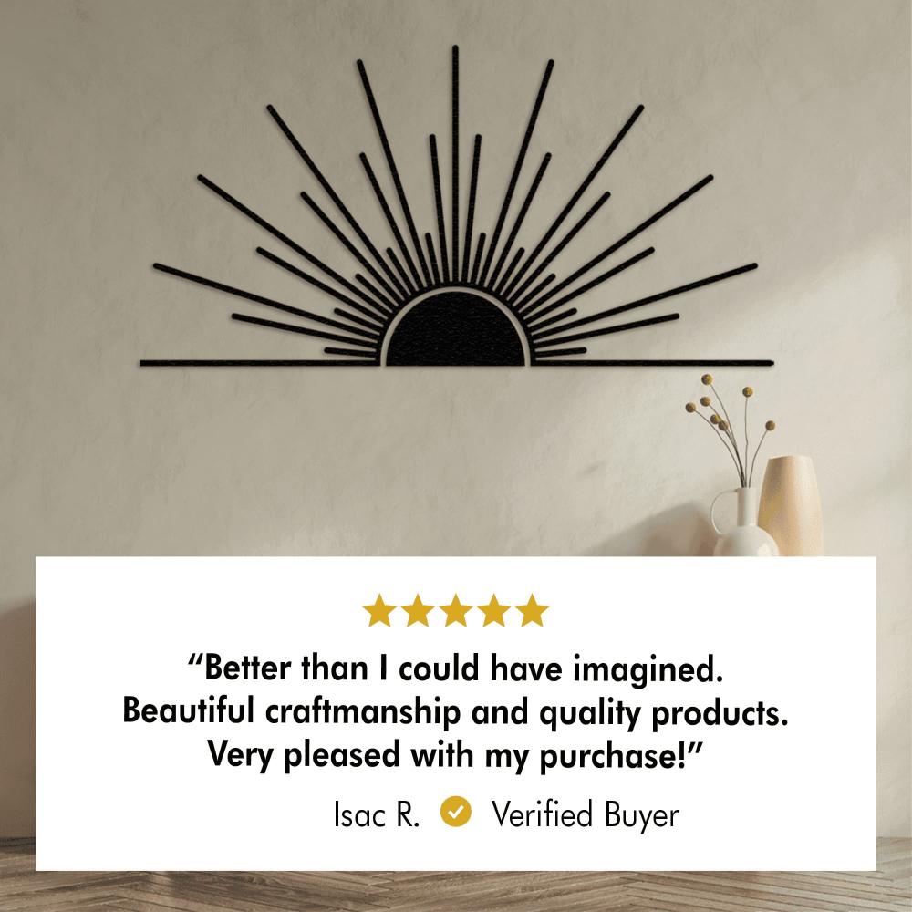 Black metal sunburst wall art with a minimalist design, featuring a customer review from a verified buyer. The review praises the craftsmanship and quality, awarding the product 5 stars. 