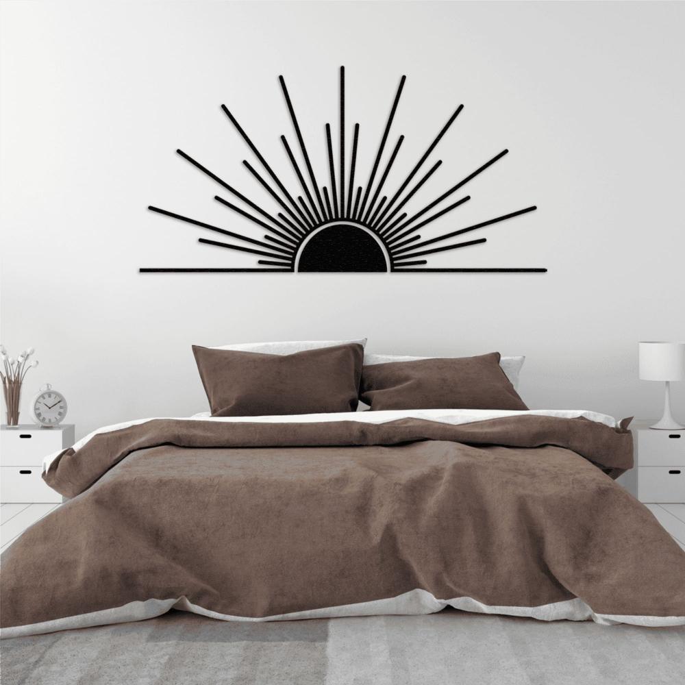 Minimalist sunburst metal wall art in black, positioned above a modern bed with brown bedding. The sunrise design radiates across the wall, creating a striking focal point in the bedroom. 