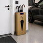 Modern gold metal umbrella stand with umbrella cutout design freestanding in luxury garage entryway