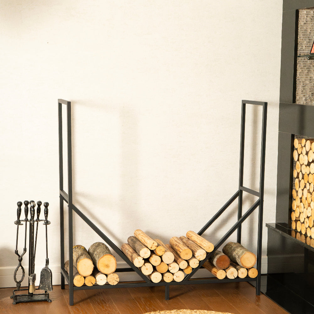 Firewood rack with logs inside, fireplace tools on the left, and a decorative wall piece on the right.
