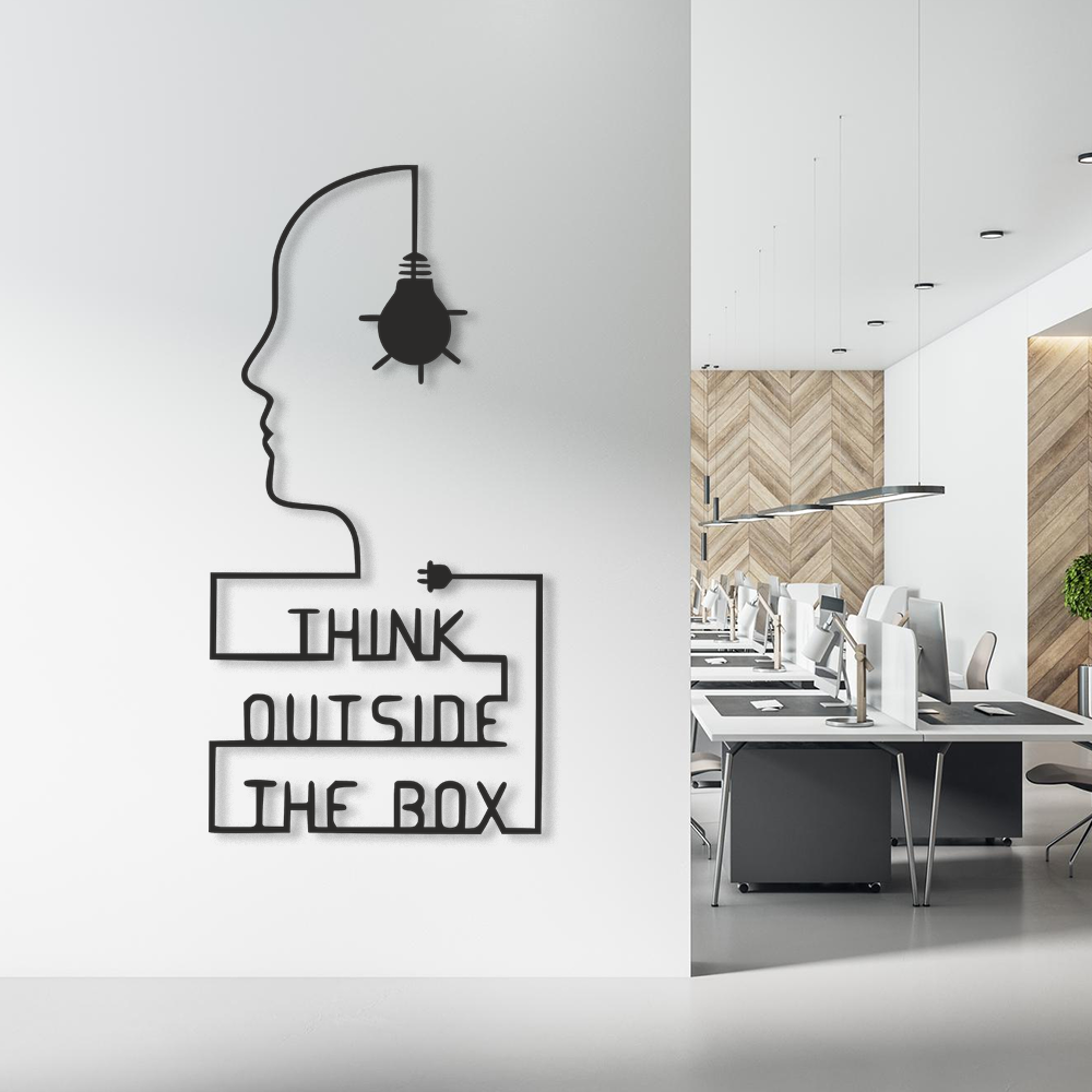 Modern office interior with 'Think Outside the Box' lettering wall art mounted on a feature wall.