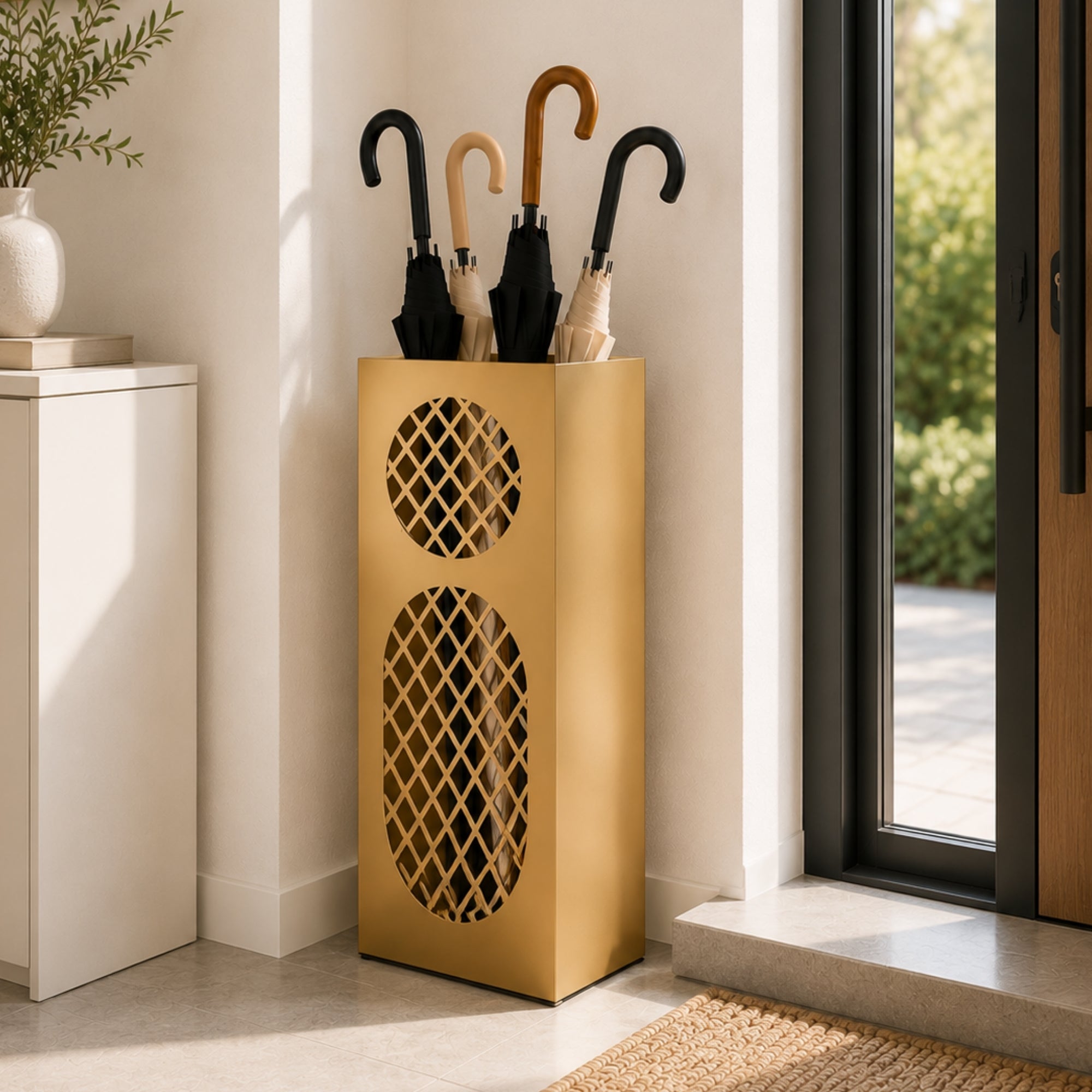 Gold oval mesh metal umbrella stand in contemporary entryway with warm minimalist decor