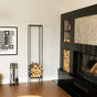 Modern living room with a black fireplace, firewood stand, and decorative items. indoor firewood rack, tall firewood storage rack