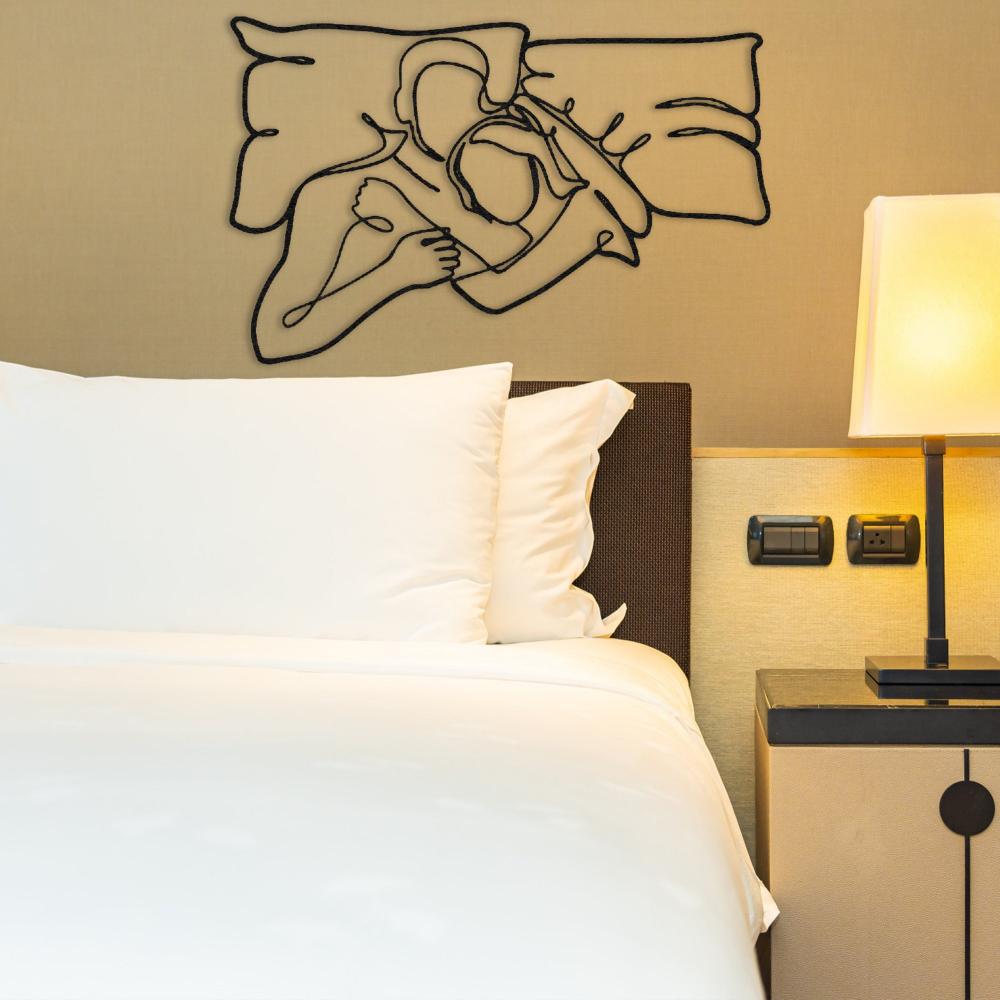Black Romantic Lying Couple Line Art Metal Wall Art in a bedroom