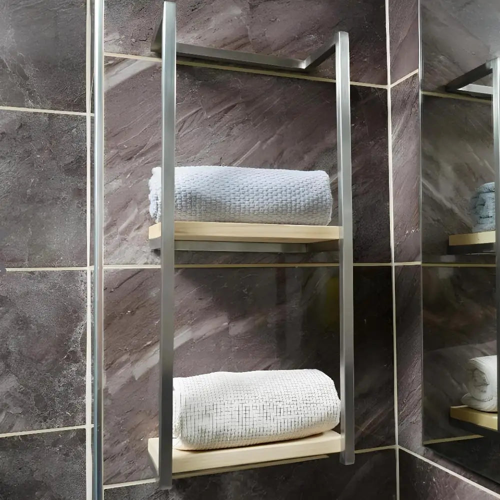 Image of a Satine Nickel-finished wall-mounted towel rack in a modern bathroom setting. The rack features two wood-plank shelves, each holding a neatly rolled white towel.