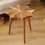 Snowflake Epoxy Side Table with white inlay pattern, placed on a wooden floor in a cozy living room with neutral decor.
