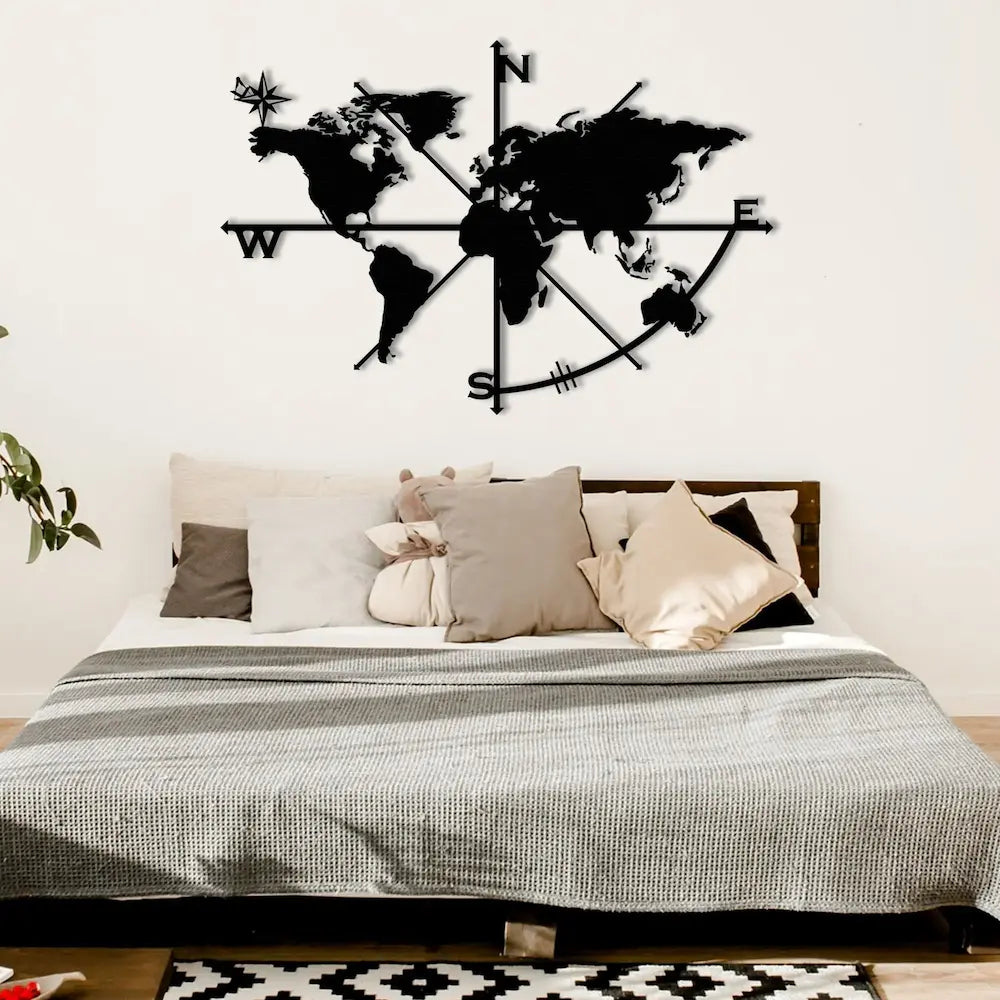 Compass design metal wall art mounted in a minimalist bedroom.