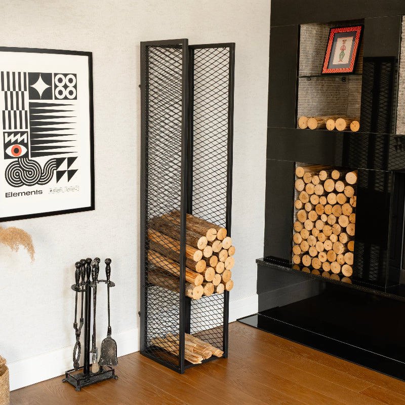 Fireplace with wood storage rack, fireplace tools, and decorative elements.