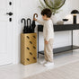 Gold metal umbrella stand with multi-umbrella icon pattern in luxury entryway with child reaching for umbrella