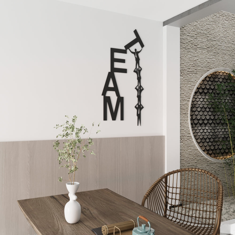TEAM metal wall art with figures lifting the T in modern dining space