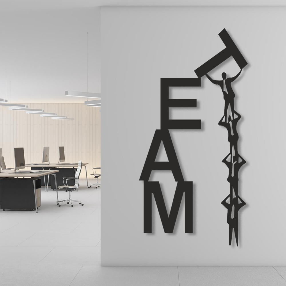 Decorative wall art with 'TEAM' letters and a silhouette of people in an office setting.