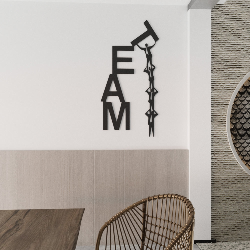 Decorative wall art spelling 'TEAM' in a modern interior setting with a table and chair.