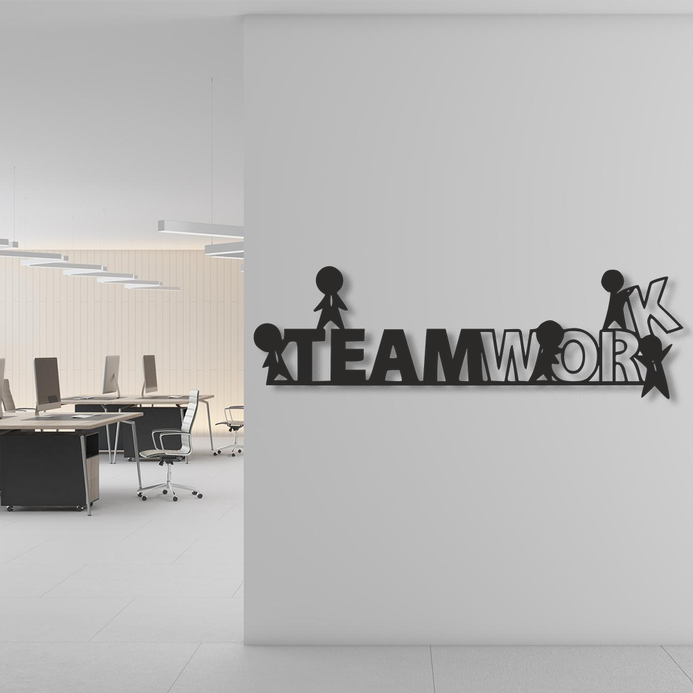 Decorative wall art with 'TEAMWORK' on a white wall in an office setting