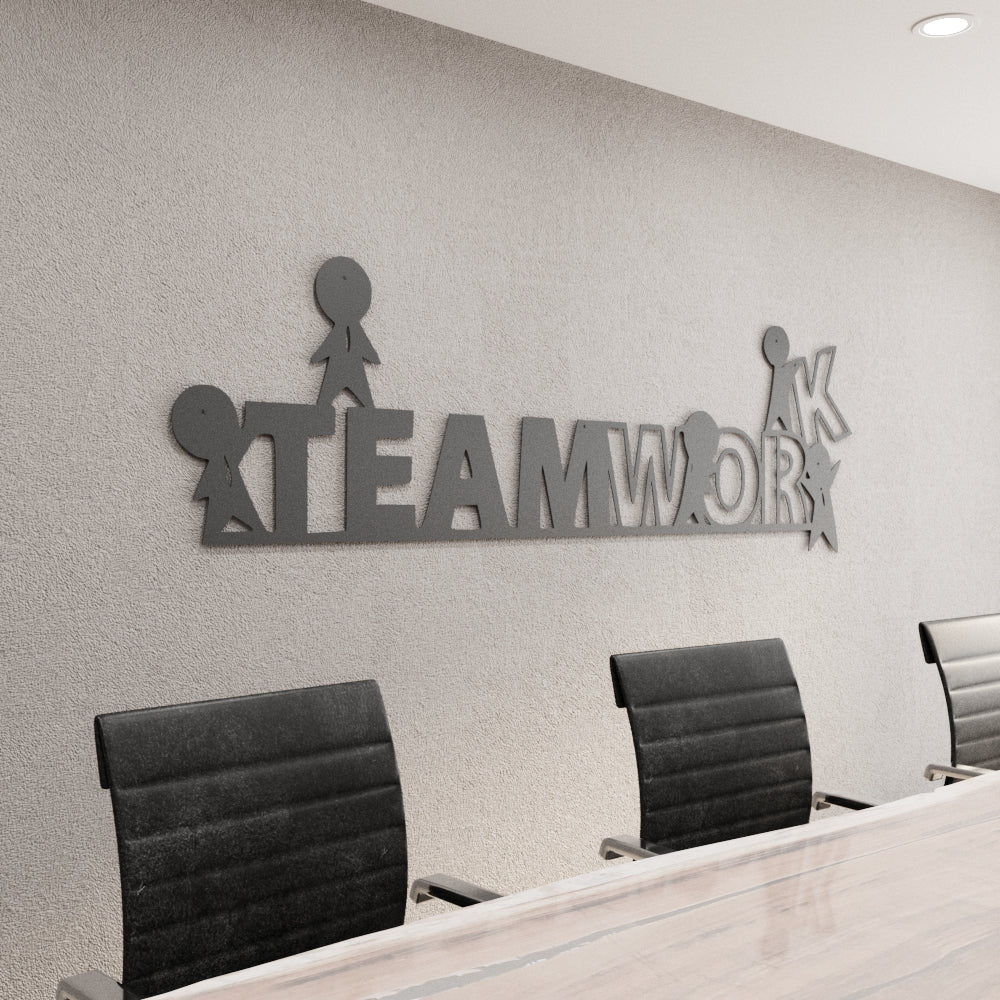 Decorative wall art with 'TEAMWORK' on a wall above office chairs.