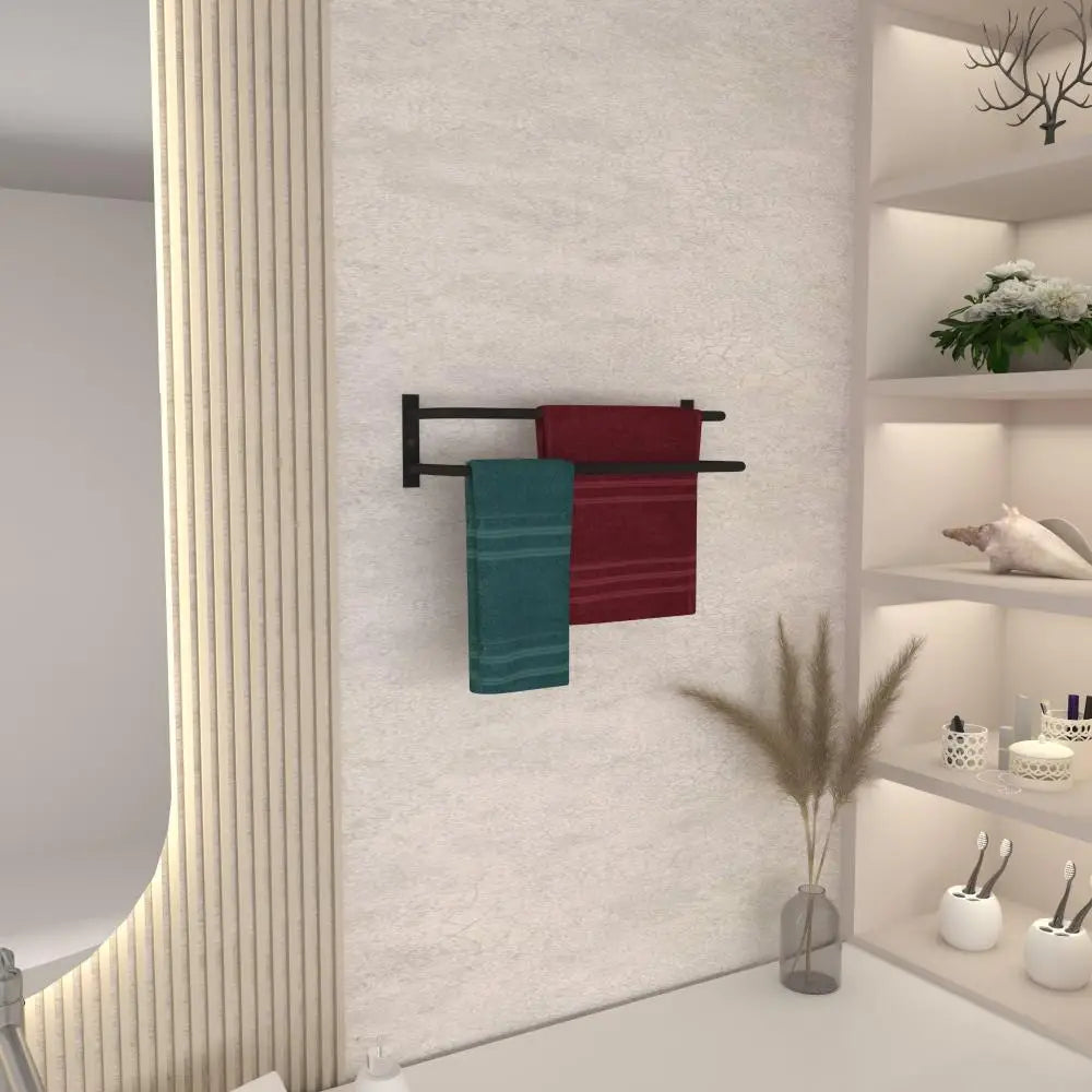 A black towel holder mounted on a wall, holding a burgundy and a teal towel, with modern decor in the background.