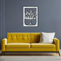 A stylish living room with a yellow tufted sofa against a gray wall, decorated with a white "Vase with Succulent" metal wall art, creating a fresh and modern ambiance.
