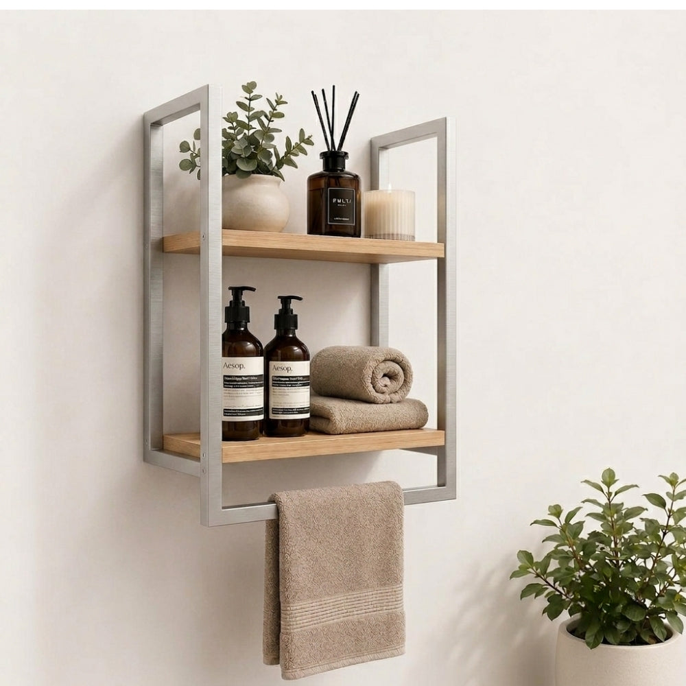 Satin nickel wall mounted 2-tier bathroom shelf with towel bar holding bathroom bottles, towels, and decor.