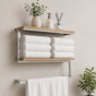 Satin nickel wall mounted 2-tier towel shelf with towel bar holding folded towels and bathroom decor.
