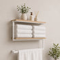 White wall mounted 2-tier towel shelf with towel bar holding folded towels and bathroom decor.