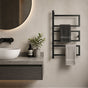 Black wall mounted 3-tier towel rack holding two towels beside a modern bathroom vanity.