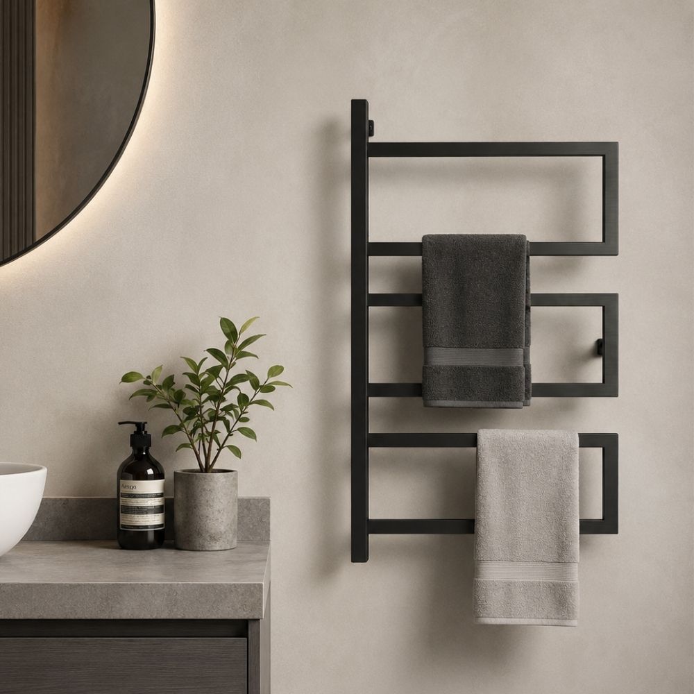 Close-up of black wall mounted 3-tier towel rack holding dark and light towels in a modern bathroom.
