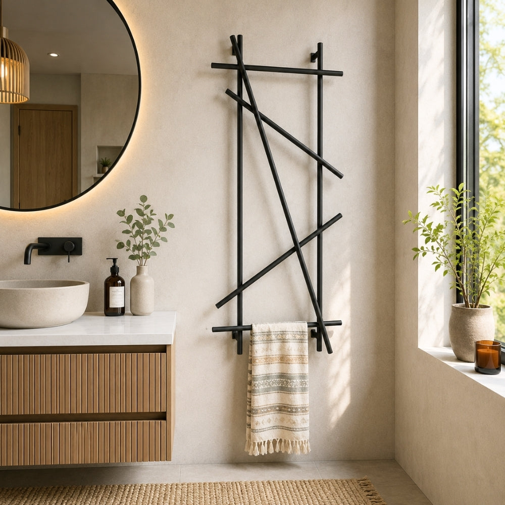 Black wall mounted branch towel rack and coat rack styled in a modern bathroom.
