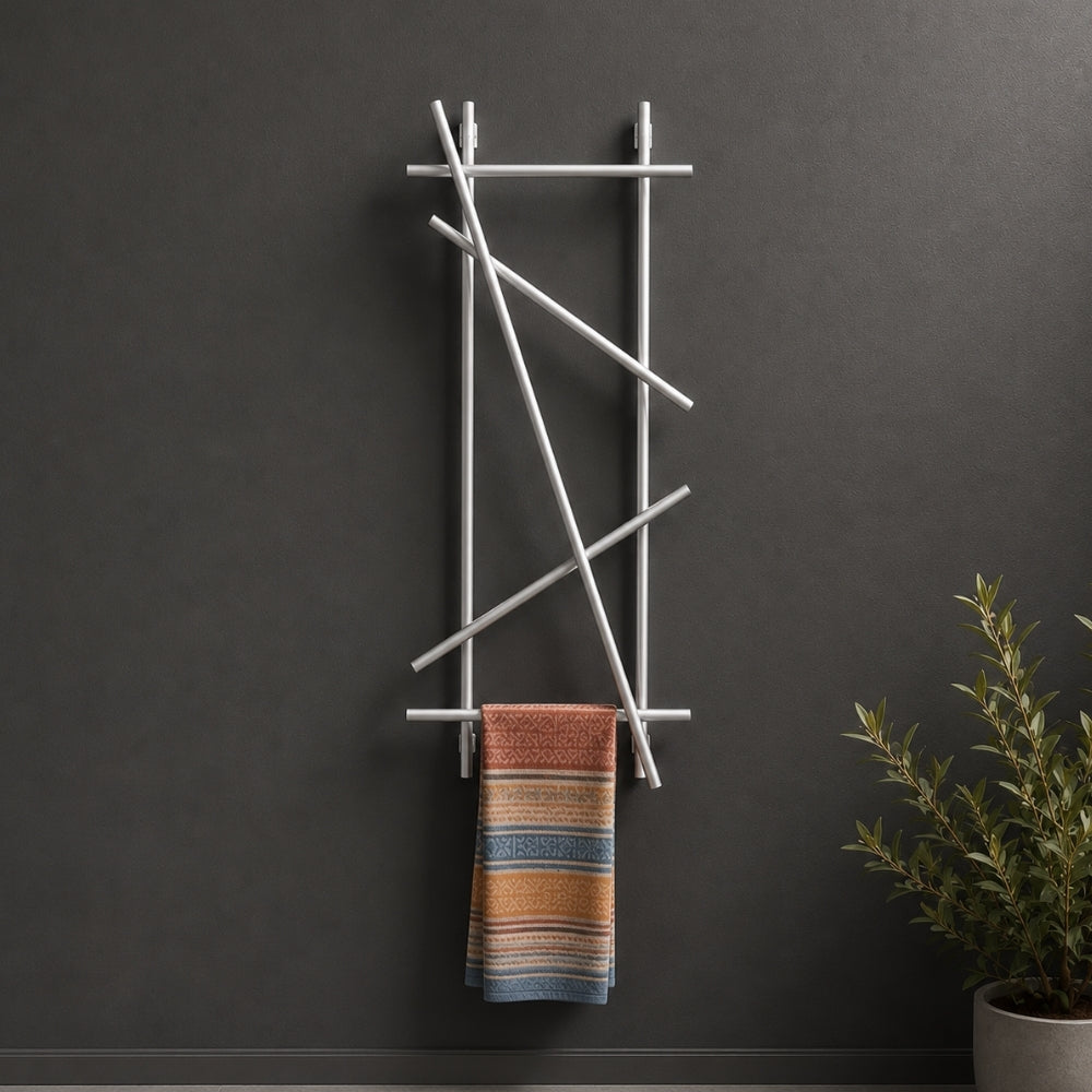 Satin nickel wall mounted branch towel rack and coat rack holding a patterned towel on a dark wall.