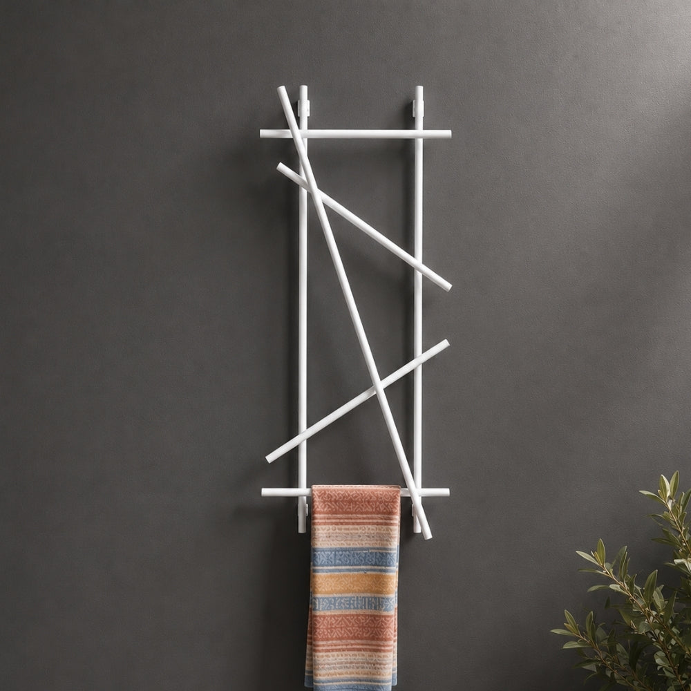 White wall mounted branch towel rack and coat rack holding a patterned towel on a dark wall.