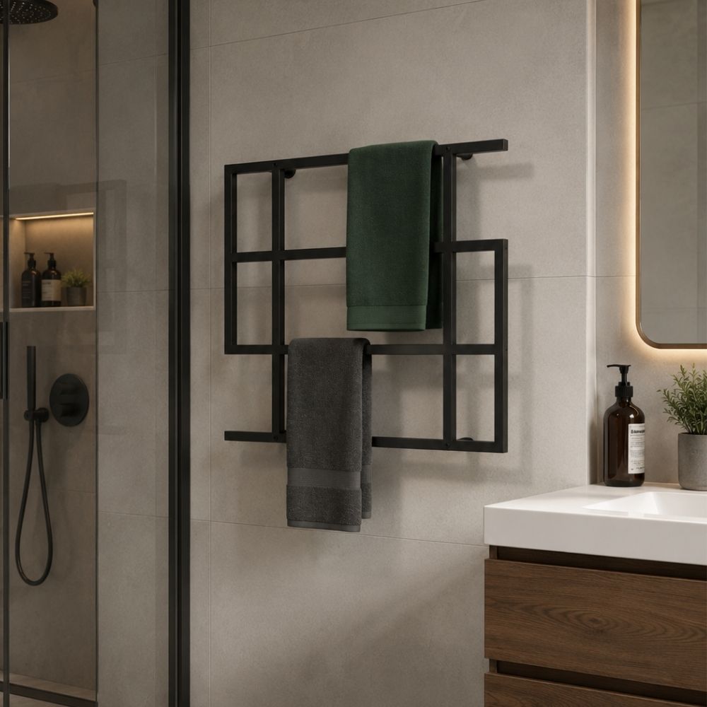 Black wall mounted geometric towel rack holding towels near a shower in a modern bathroom.