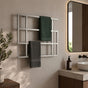 Satin nickel wall mounted geometric towel rack holding green and gray towels beside a modern bathroom vanity.